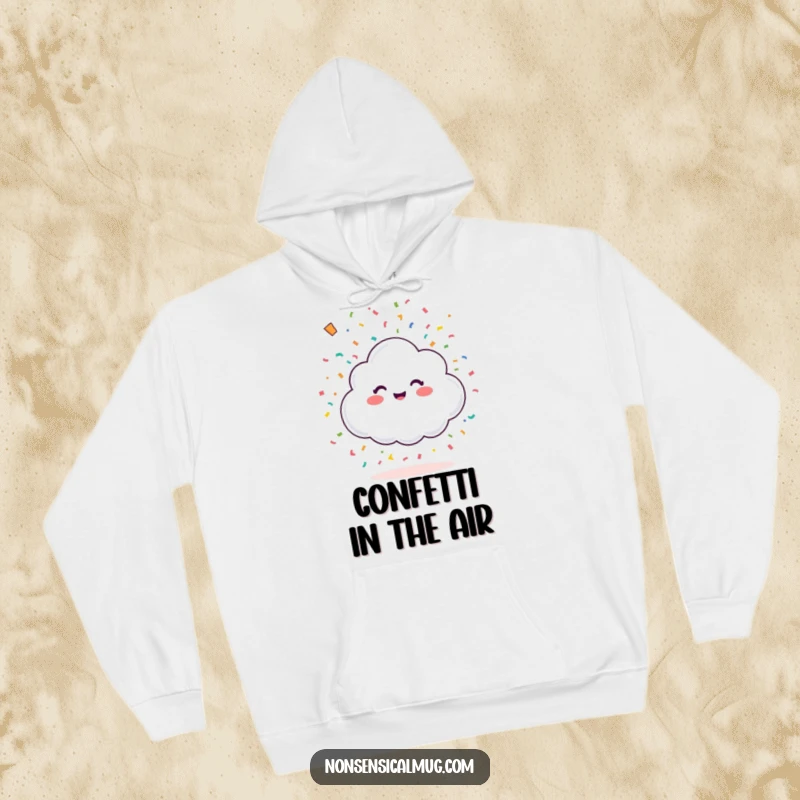 Funny happy little cloud showering colorful confetti from above on a cozy hoodie, combining warmth with festive celebration.