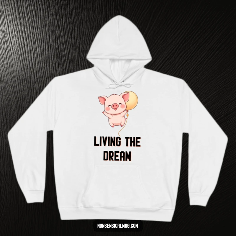 Funny Kawaii Piglet Balloon Hoodie: A cute, smiling piglet drifts serenely upwards on a balloon, offering warmth and whimsical delight.