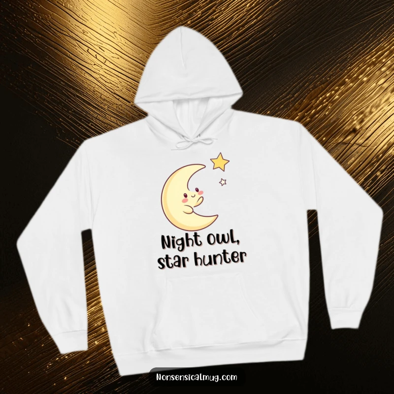 Funny hoodie with a whimsical crescent moon character actively chasing a bright twinkling star across a dark, cosmic backdrop.