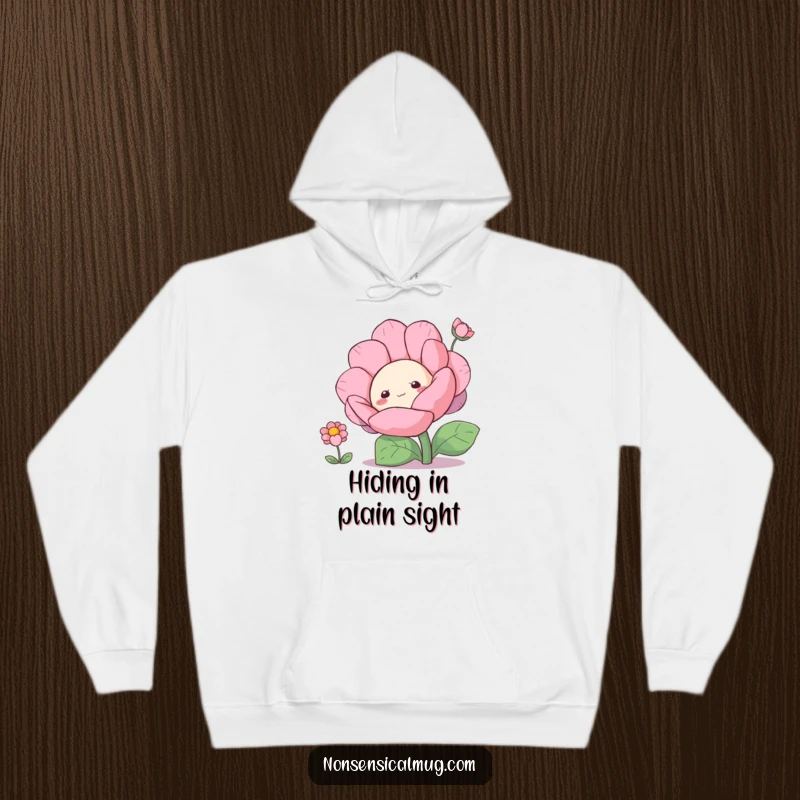 Funny curious blob character peeking from behind a large flower on a cozy hoodie, radiating charm.