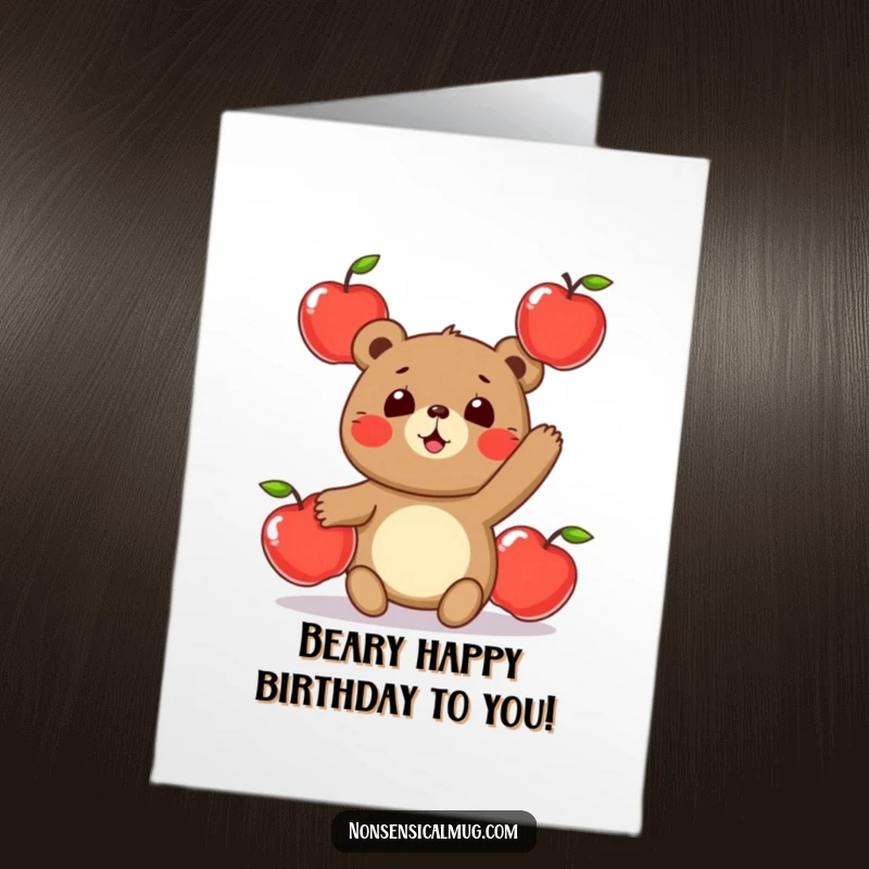 Funny free printable birthday card: a round bear character playfully juggling three shiny apples, looking comical.