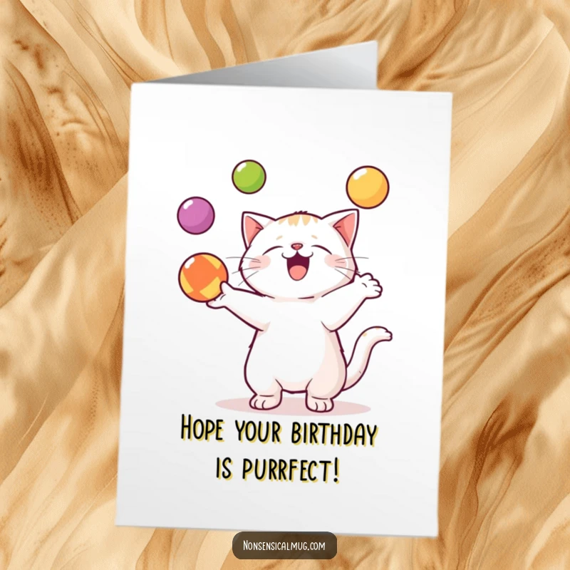 Funny Free Printable Birthday Card showing a kawaii cat skillfully and enthusiastically juggling three colorful balls with a smile.