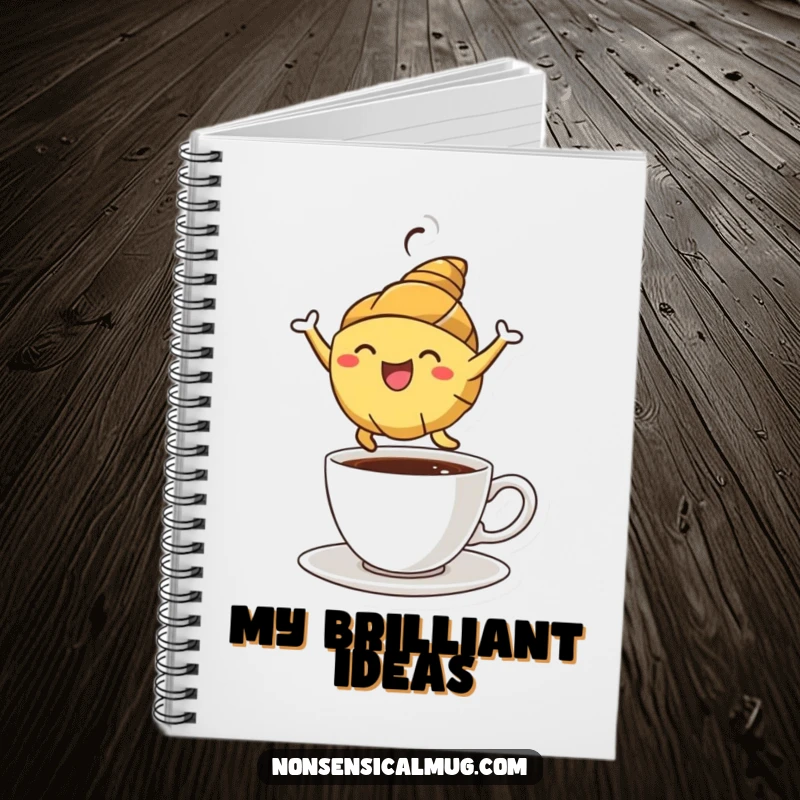Funny croissant character energetically leaping over a coffee cup on the cover of a notebook, inspiring creativity.