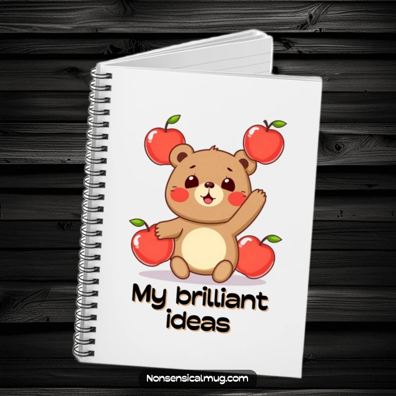 Funny notebook cover with a round, smiling bear character playfully juggling three shiny apples, designed to inspire creativity.
